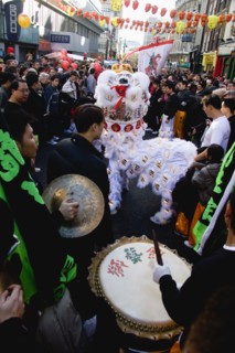 ENGLAND, London, Chinatown, Lion Dance troupe performing in Wardour Street amongst the crowd