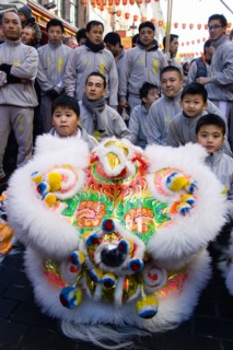 ENGLAND, London, Chinatown, Lion Dance troupe performing in Gerrard Street during Chinese New Year