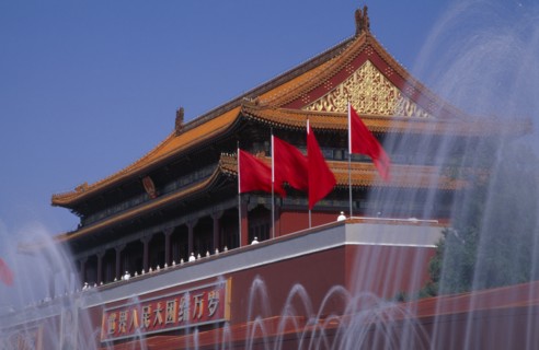 CHINA, Beijing, "Fountains and entrance gateway to the Forbidden City with red flags and red and