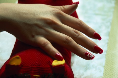 CHINA, Beijing, "Close cropped shot of manicured and painted nails with red nail polish, white