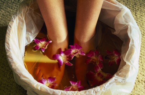 CHINA, Beijing, Bodhi Theraputic Retreat.  Close cropped shot of feet soaking in water scattered