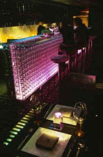 CHINA, Beijing, Tou Ming Si Kao ( TMSK ) bar interior with couple sitting at glass bar illuminated