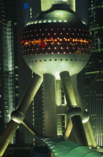 CHINA, Shanghai, Part view of the Oriental Pearl Tower exterior illuminated at night.