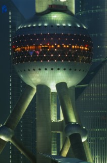 CHINA, Shanghai, Part view of the Oriental Pearl Tower exterior illuminated at night.