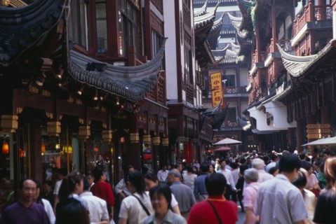 CHINA, Shanghai, "Yu Gardens, Old City.  Crowds of shoppers in narrow street lined with shop fronts