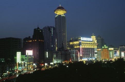 CHINA, Shanghai, "Renmin Square or the People’s Square at night, with buildings illuminated with