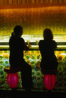 CHINA, Shanghai, Xintiandi District.  Tou Ming Si Kao ( TMSK ) bar interior with two figures having