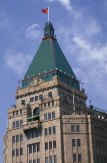 CHINA, Shanghai, The Peace Hotel on the Bund.  Detail of exterior tower with green rooftop and