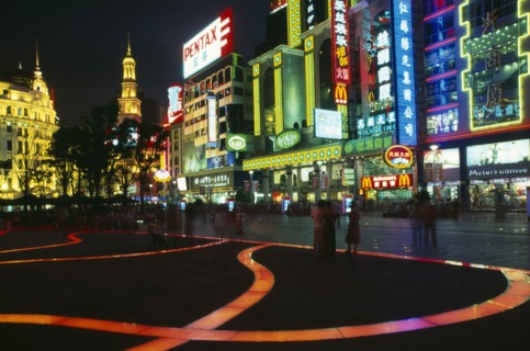 CHINA, Shanghai, "Nanjing Lu.  Busy street scene at night with illuminated shop fronts, neon signs