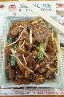 CHINA, Shanghai, Rectangular dish of seseme pork with pair of chopsticks lying across top corner.