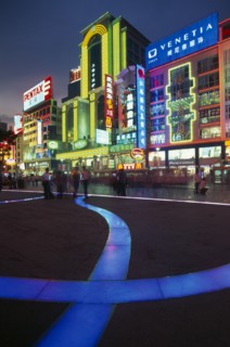 CHINA, Shanghai, Nanjing Lu.  Busy street scene at night with illuminated neon signs and