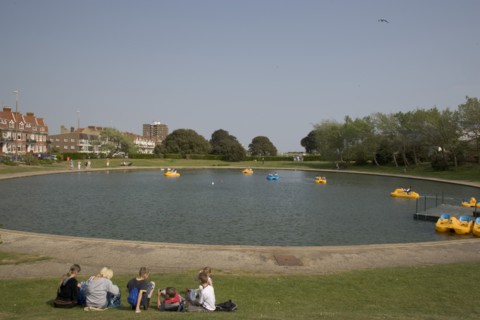 ENGLAND, West Sussex, Littlehampton, Families enjoying pedal boat rides at Oyster Pond Boating Lake