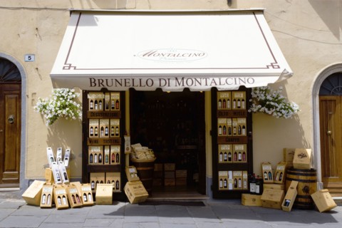 ITALY, Tuscany, Montalcino, Wine shop in the medieval hilltown with a display of wines on the