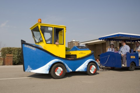 ENGLAND, West Sussex, Littlehampton, Families enjoying seafront promenade tourist train