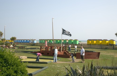 ENGLAND, West Sussex, Littlehampton, Families enjoying pitch and putt mini golf games in Norfolk