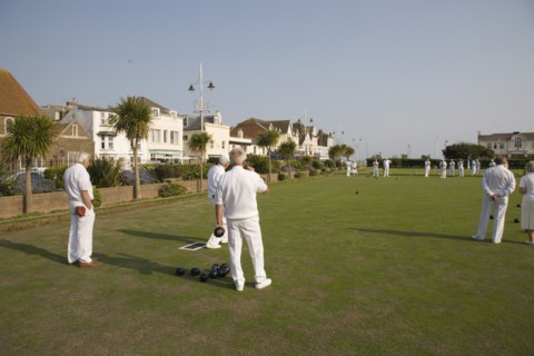 ENGLAND, West Sussex, Bognor Regis, Men playing a game of bowls on green