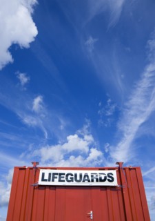 ENGLAND, West Sussex, Littlehampton, Red shipping container used as a lifeguards hut on the beach