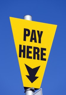 ENGLAND, West Sussex, Littlehampton, Yellow car park sign against a blue sky with black writing