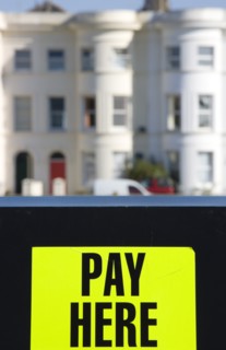 ENGLAND, West Sussex, Littlehampton, Yellow car park sign with black writing saying Pay Here with