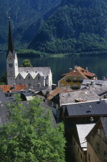 AUSTRIA, Oberosterreich, Hallstatt, "View over tiled village rooftops, hotel and church with