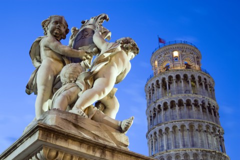 ITALY, Tuscany, Pisa, An illuminated statue in The Piazza del Duomo of cherubs holding a shield