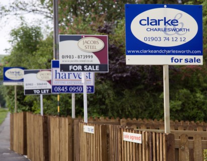 ENGLAND, West Sussex, Washington, To Let and For Sale signs on wooden fencing outside a newly built