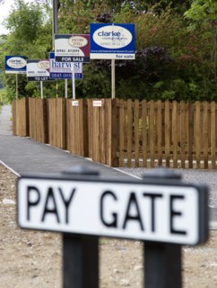 ENGLAND, West Sussex, Washington, To Let and For Sale signs on wooden fencing outside a newly built