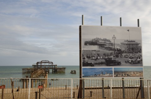 ENGLAND, East Sussex, Brighton, Ruins of the West pier with boards showing the pier in its former