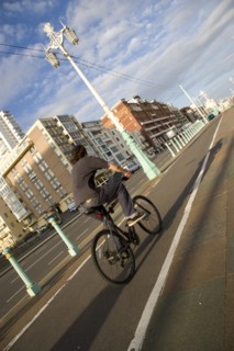 ENGLAND, East Sussex, Brighton, Cyclist on the prommenade cycle lane.