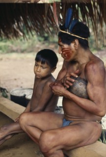 COLOMBIA, North West Amazon, Vaupes, Maku hunter  face painted with red Achiote marks and wearing