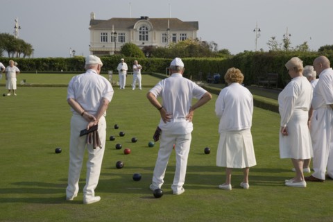 ENGLAND, West Sussex, Bognor Regis, Men and women playing a game of bowls on beach front green