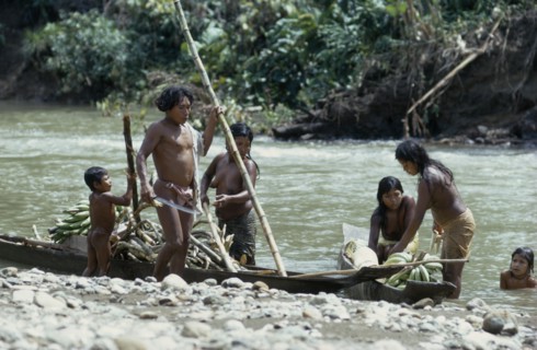 COLOMBIA, Choco, Embera Indigenous People, "Embera family arrive back at riverside home by dug-out