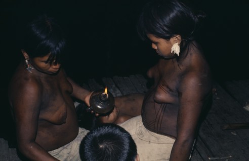 COLOMBIA, Choco, Embera Indigenous People, Young Embera daughters of the household painting their