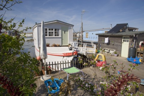ENGLAND, West Sussex, Shoreham-by-Sea, Houseboat moored along the banks of the river adur.  Former