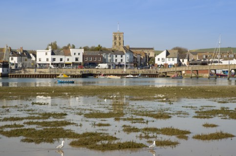 ENGLAND, West Sussex, Shoreham-by-Sea, View across the river Adur mud flats toward the won centre.