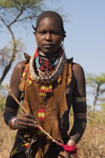ETHIOPIA, Lower Omo Valley, Tumi, "Dombo village, Hamer lady holding spoon she has used to stir
