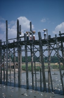 THAILAND, North, Bridges, Women carrying baskets on their heads crossing high wooden bridge across