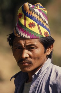 NEPAL, East, Chainpur, Head and shoulders portrait of a man wearing a Topi  traditional hat near