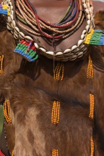 ETHIOPIA, Omo Valley, Mago National Park, Womans necklaces and traditional goatskin dress decorated