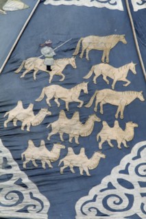 MONGOLIA, Ulan Bator, "Detail of ancient silk tapestry depicting man on horseback herding camels