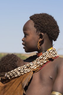 ETHIOPIA, Lower Omo Valley, Tumi, Dombo village (Hamer peoples) Hamer lady with baby in goatskin