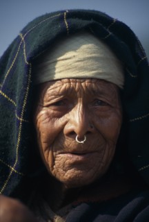 NEPAL, Dhorpatan Trek, Near Sibang, Head and shoulders portrait of elderly woman wearing a nose
