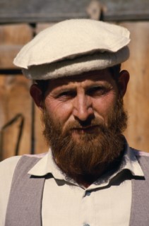 PAKISTAN, North West Frontier, Chitral, Head and shoulders portrait of a man with a beard wearing a