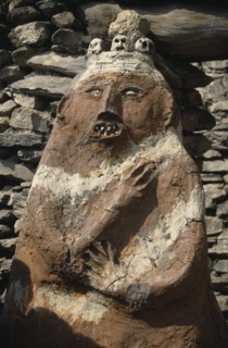 NEPAL, Annapurna Region, Jharkot, Circuit Trek. Male animistic protector deity beside the gateway