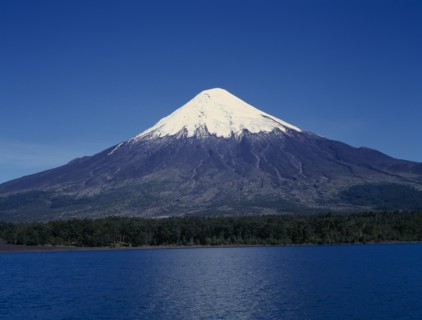 CHILE, Los Lagos, Osorno Volcano, Snow capped peak of volcano above lake near Puerto Montt.