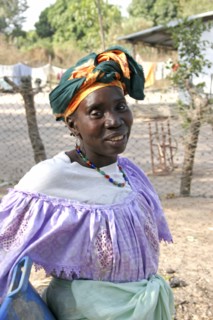 GAMBIA, Western Gambia, Tanji, Tanji village.  Three-quarter portrait of woman wearing traditional