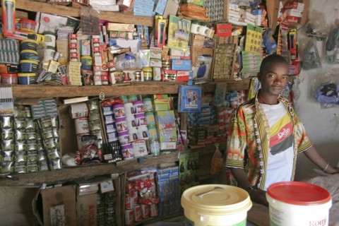 GAMBIA, Western Gambia, Tanji, "Tanji Village.  Young, male owner of a grocery shop standing behind