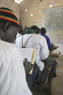 GAMBIA, Western Gambia, Tanji, Tanji Village.  Muslim boys writing in arabic at their desks while