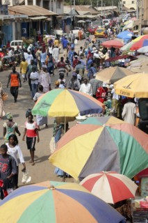 GAMBIA, Western Gambia, Serekunda, "Bakau Market, Atlantic Road.  Busy city street lined with