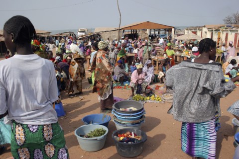 GAMBIA, Western Gambia, Tanji, Busy market scene with women selling fruit and vegetables and